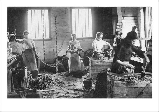 The front of the greetings card of young women chainmakers at work around 1910.